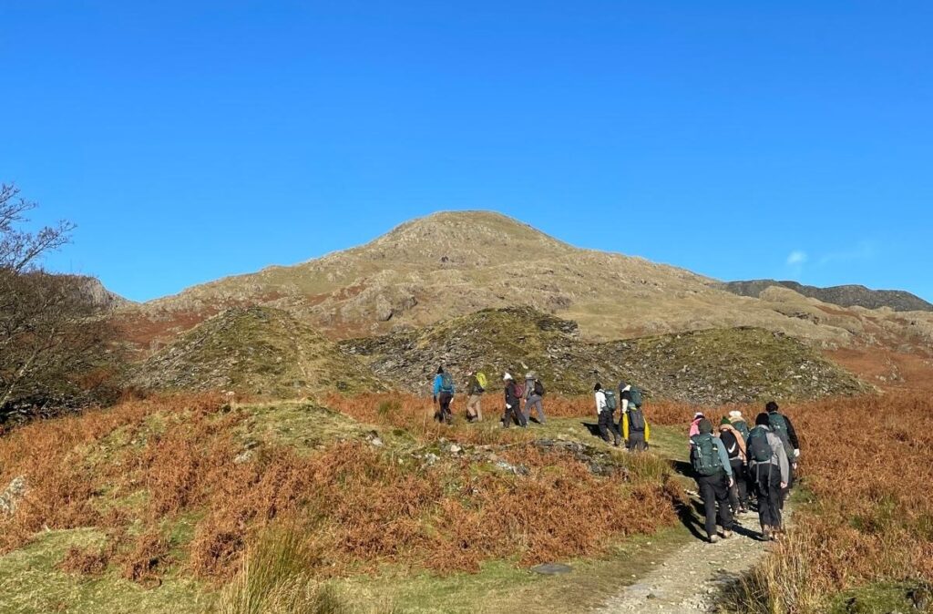 Image of some PHD Students hiking up a hill